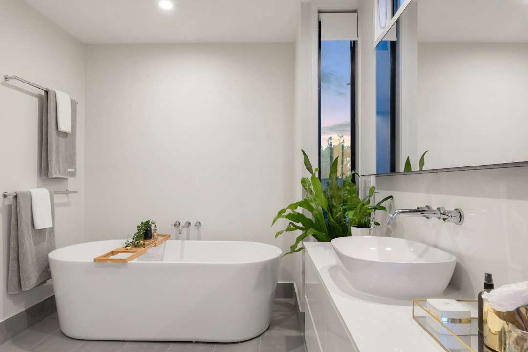 Bathroom with a freestanding bath and twin basins